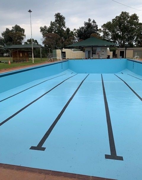 empty swimming pool showing fresh bright blue paint and black lines